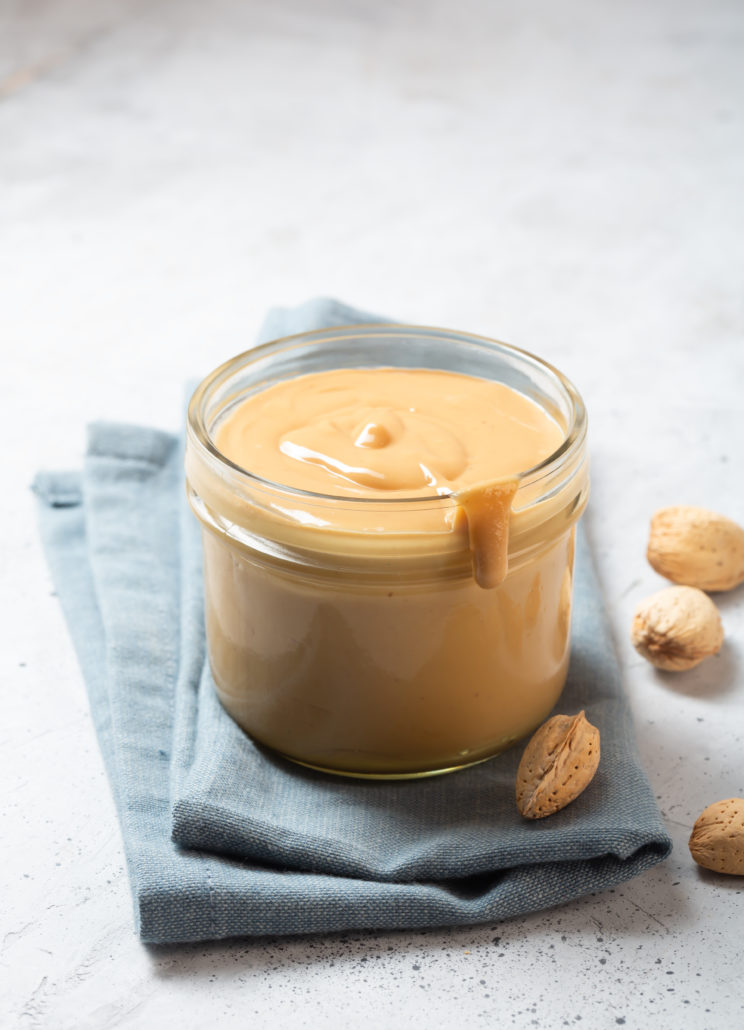 Almond butter in a glass jar on the table