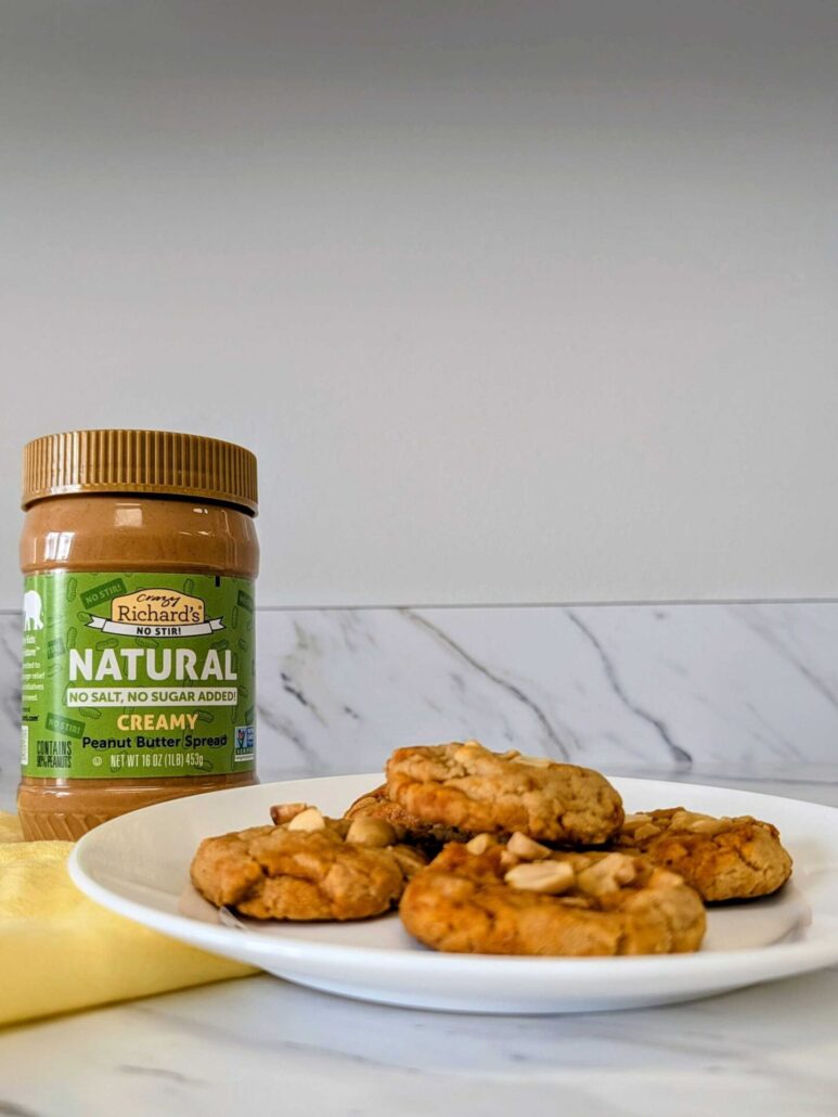 Plate of Gochujang Peanut Butter cookies next to a jar of Natural No-Stir Peanut Butter